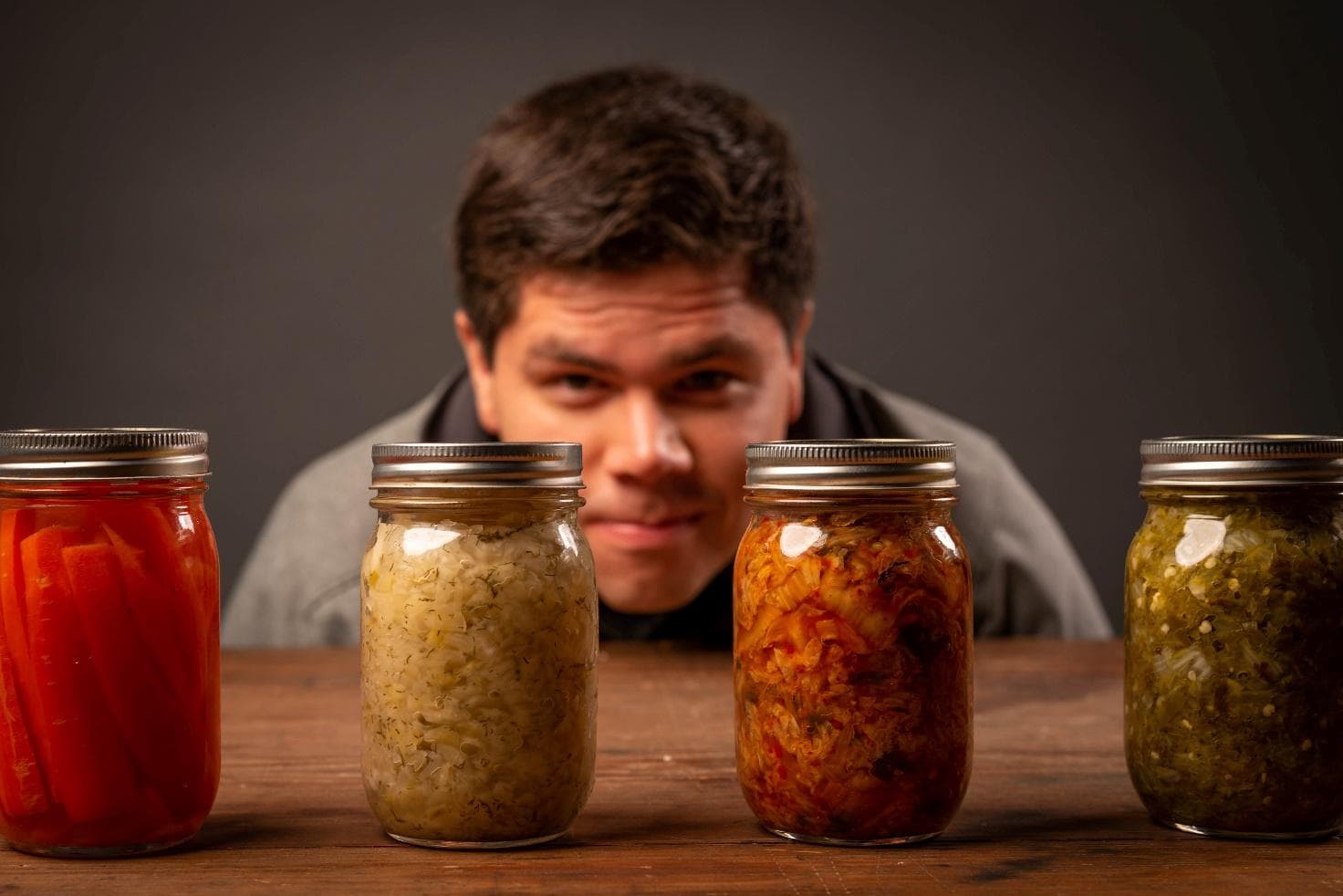 Jars of fermented foods — pickled carrots, sauerkraut, kimchi and pickles.